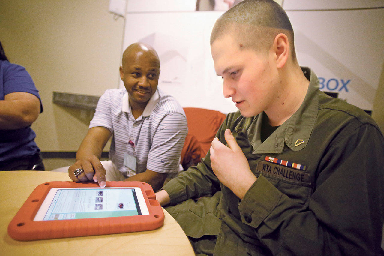 Darwin Wiggins, a case manager at the Washington Youth Academy, provides guidance to Cadet Ethan Wallace of Auburn. COURTESY PHOTO