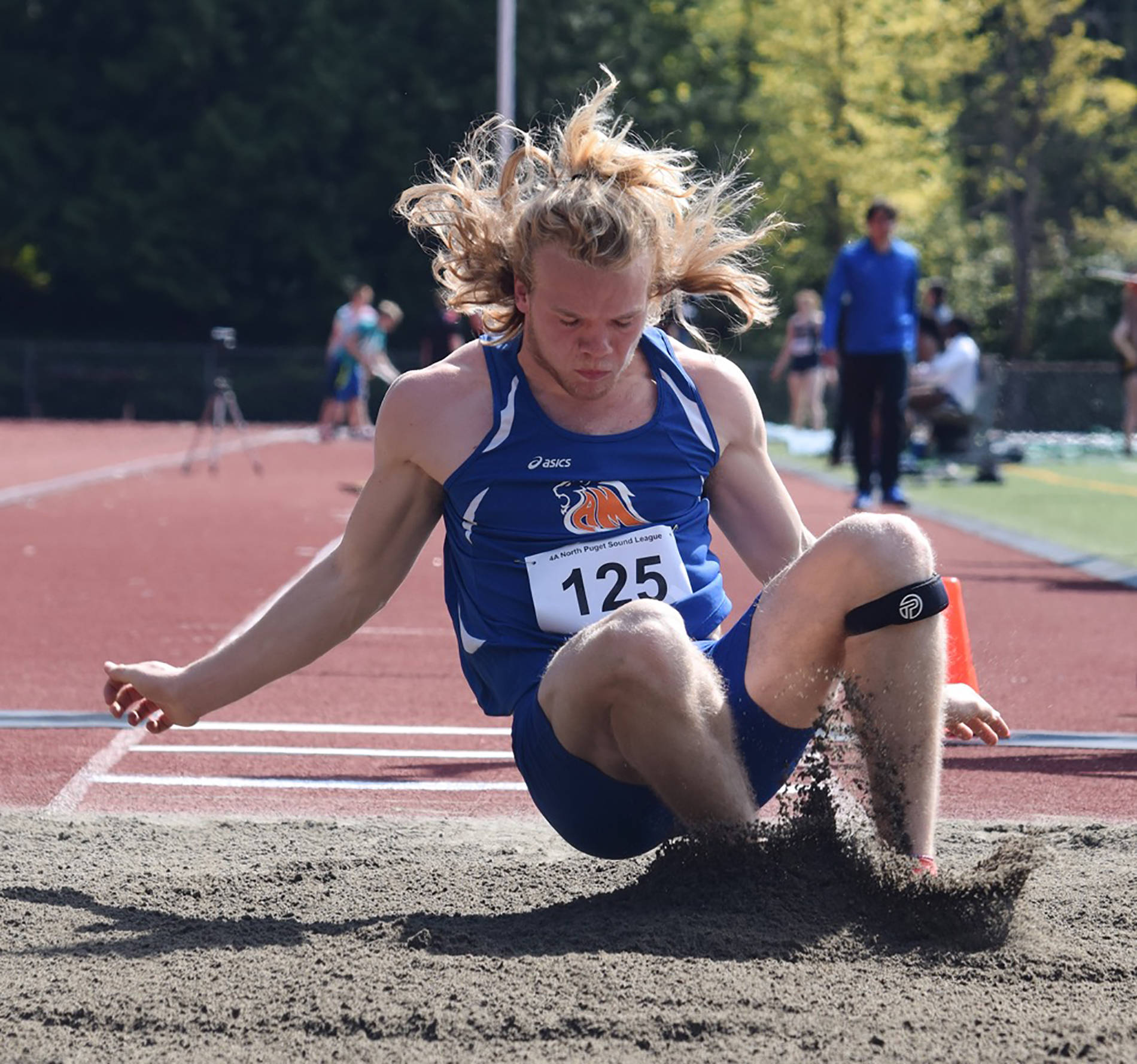 Auburn Mountainview’s Talan Alfrey lands in the sand after stretching a personal-best 21 feet, 11½ inches to take the long jump event at the 4A North Puget Sound League track and field meet last week at French Field. RACHEL CIAMPI, Auburn Reporter