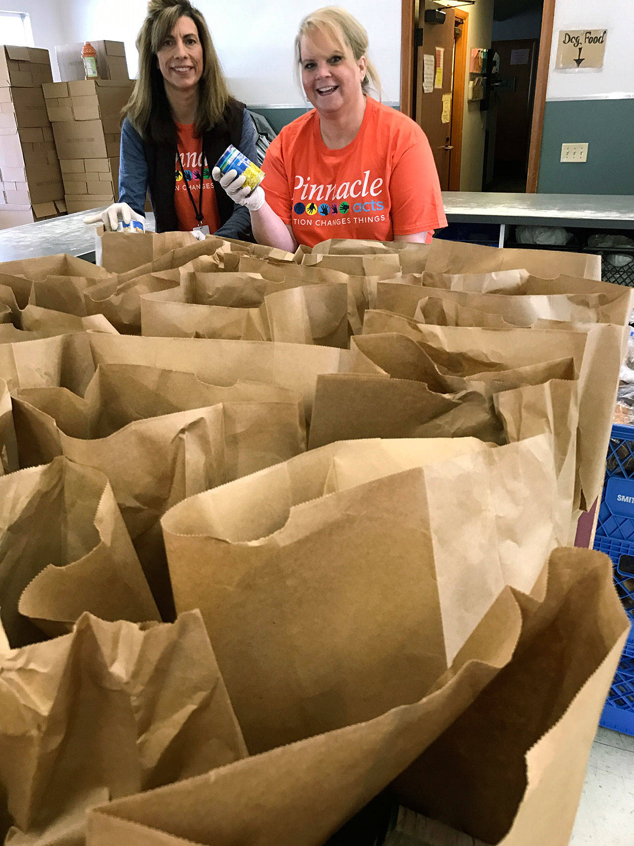 Pinnacle Foods’ Algona teammates Cindy Sankey-Hagen, left, and Karen Munson volunteered at the Auburn Food Bank, separating, sorting and bagging donated food items to provide for those in need. COURTESY PHOTO
