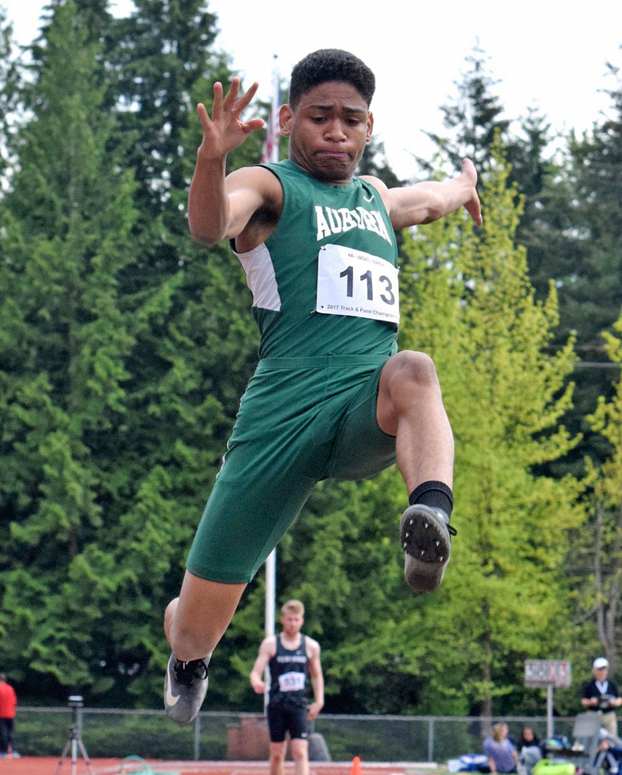 Auburn’s D’Angelo Washington soars in taking the district long jump title with a leap of 22 feet, 7 inches on Thursday at French Field. RACHEL CIAMPI, Auburn Reporter