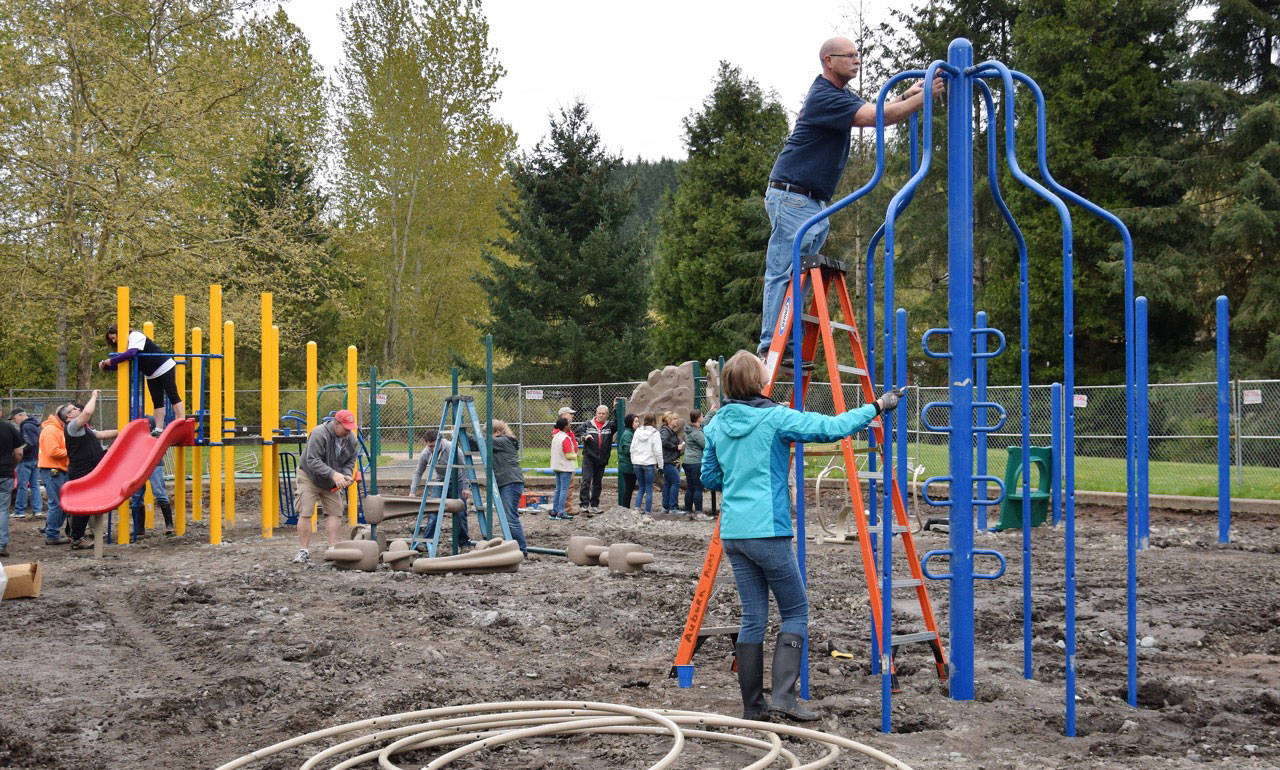 Volunteers were busy working with City staff in building a new playground at Roegner Park during Clean Sweep last month. RACHEL CIAMPI, Auburn Reporter