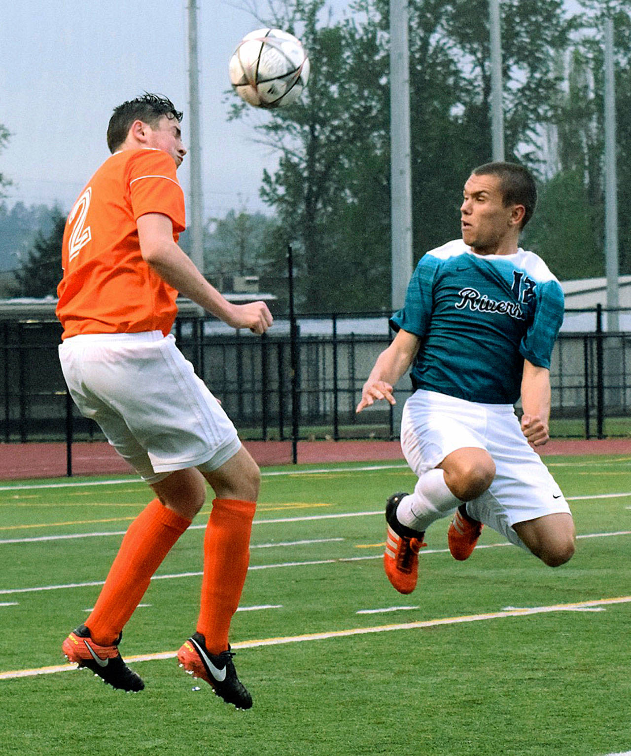 Auburn Riverside’s Cameron Zipp, right, heads the ball with Decatur’s Dennis Kozorezov defending during 4A North Puget Sound League Olympic Division play Tuesday night. RACHEL CIAMPI, Auburn Reporter