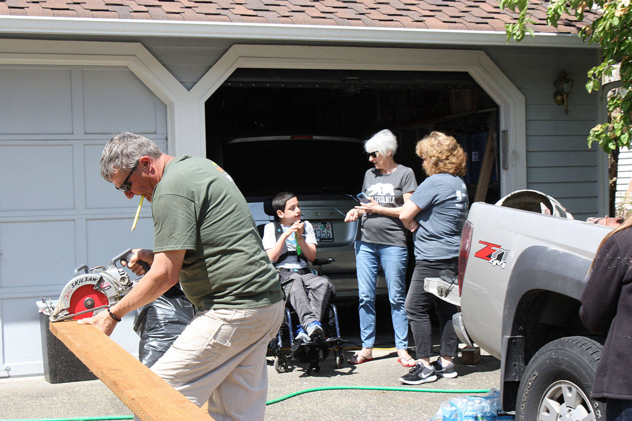 Nice gesture: Mayor Nancy Backus visits Trenton Heuring Smart and a friend while volunteers build a ramp for the Auburn boy last Saturday. COURTESY PHOTO