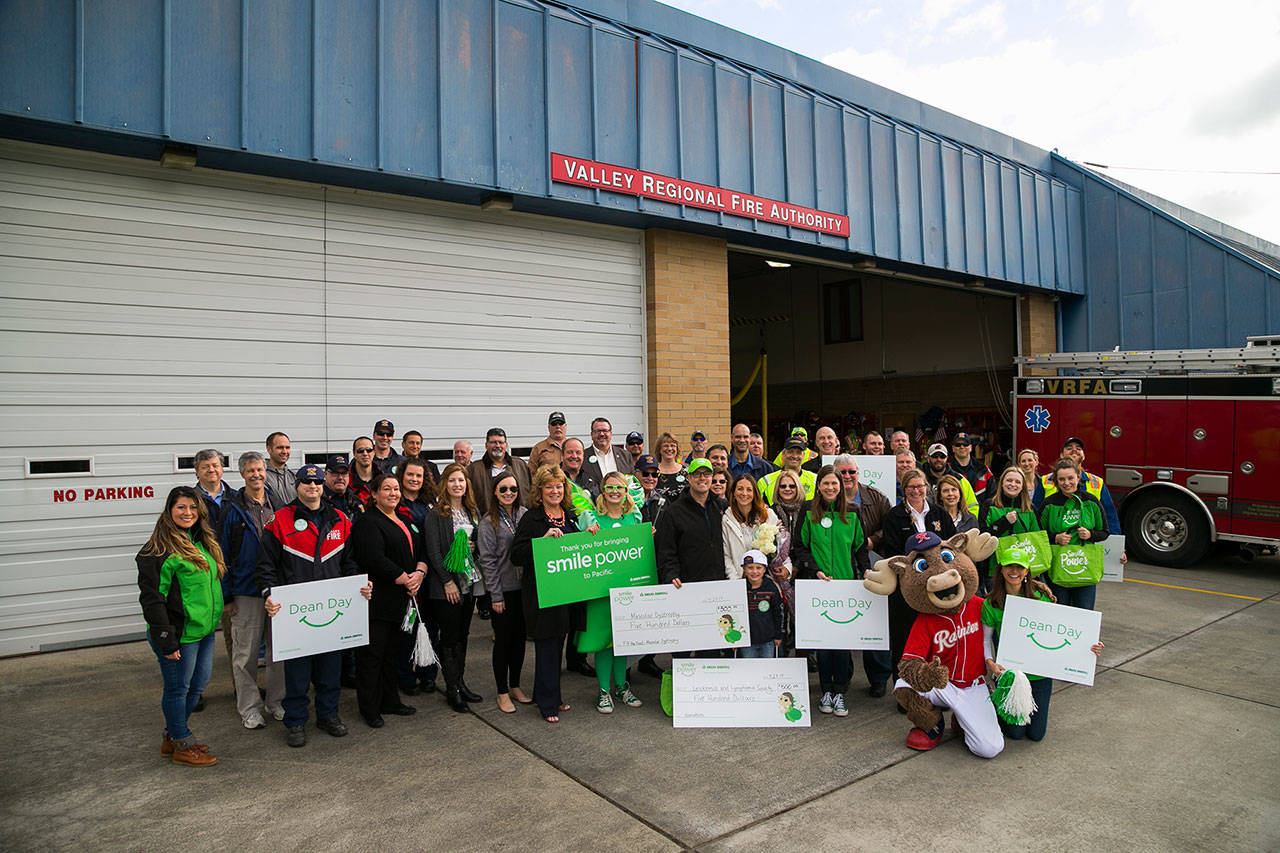 VRFA firefighters, staff, family and friends joined the Delta Dental of Washington’s Tooth Fairy and the Smile Power Team and Rhubarb from the Tacoma Rainiers at Station 38 in Pacific to surprise and honor Firefighter Dean McAuley for his charitable work in the community. COURTESY PHOTO