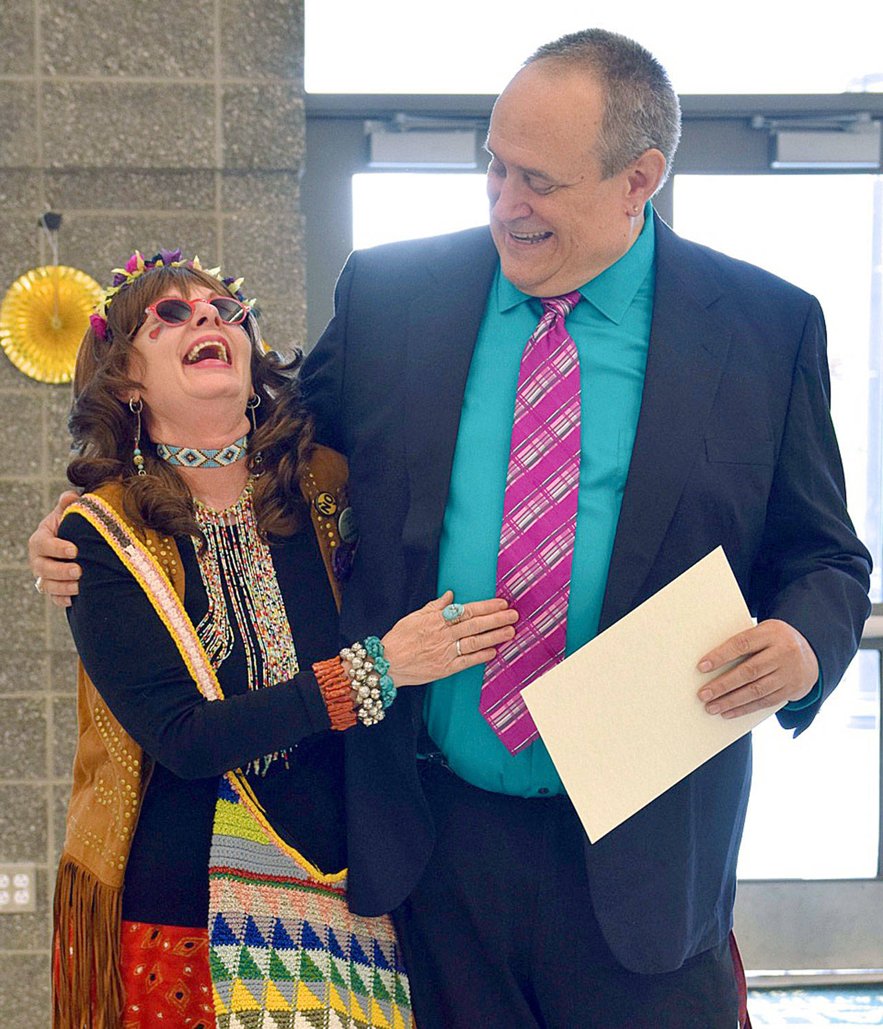 Many thanks: Auburn High School drama teacher Warren Kerr shares a laugh with costume helper Judith Cates while giving her an award of appreciation at his recent retirement program. RACHEL CIAMPI, Reporter