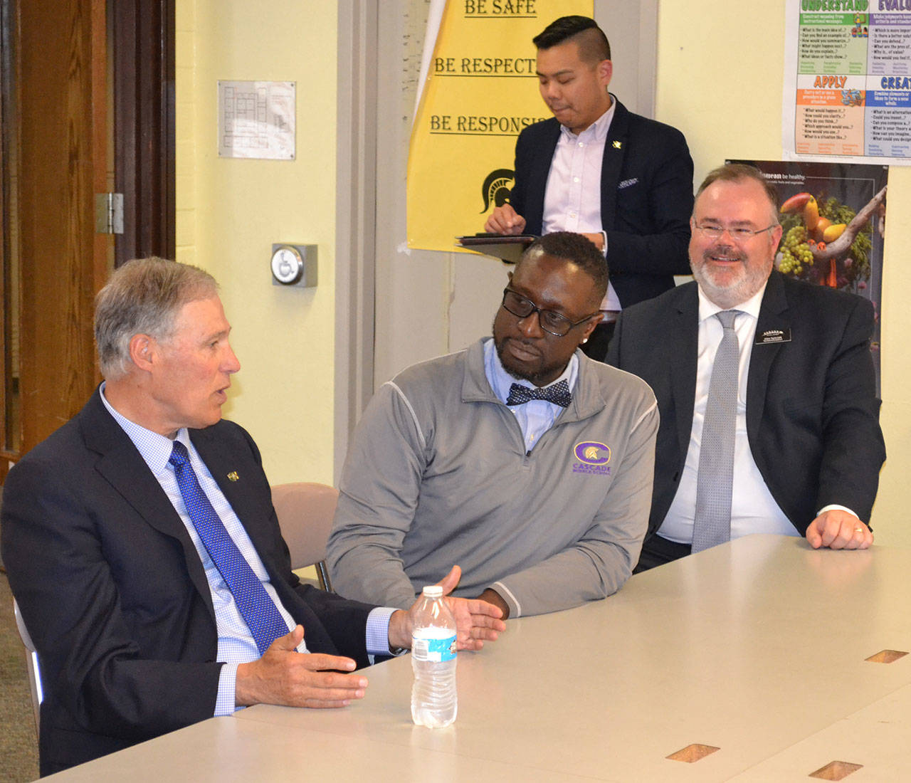 Gov. Jay Inslee sits down with teachers, support staff, Cascade Middle School Principal Isaiah Johnson, middle, and Superintendent Alan Spicciati, right, to discuss programming during his recent visit to Auburn. ROBERT WHALE, Auburn Reporter