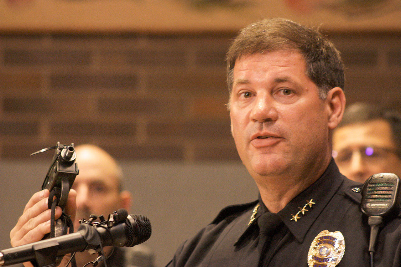 Kent Police Chief Ken Thomas shows a gun at a Monday news conference at City Hall confiscated during a March crime. Mark Klaas/Kent Reporter
