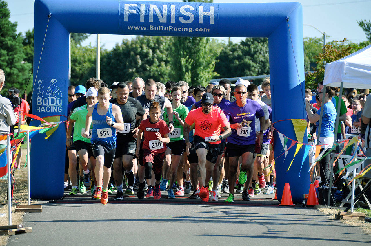 They’re off: Auburn’s Tyler Flannery (No. 551), left, and the pack leave the starting line for the Kent Cornucopia Days 5K last Saturday. Flannery, who runs for Seattle University, topped the field in 16 minutes, 10.7 seconds. HEIDI SANDERS, Reporter