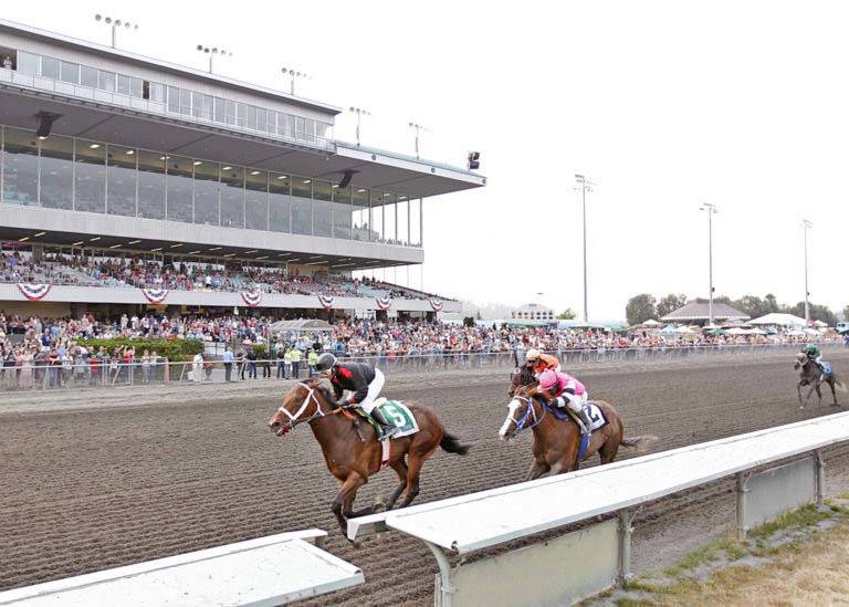 Jennifer Whitaker and Elliott Bay, left, held off Sippin Fire to capture Sunday’s $50,000 WTBOA Lads Stakes for 2-year-old colts and geldings at Emerald Downs. COURTESY TRACK PHOTO