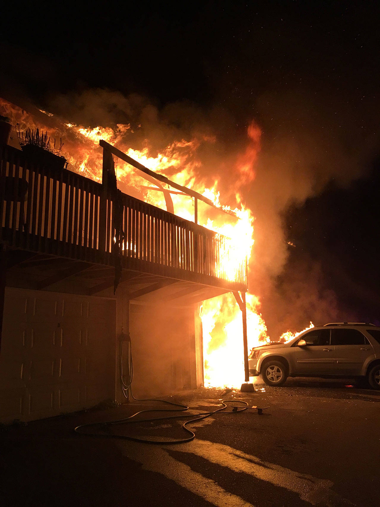 A fire engulfs a four-plex building in northeast Auburn on July 19, killing a man and his son. VRFA investigators determined the fire was caused by unattended cooking. COURTESY PHOTO, VRFA