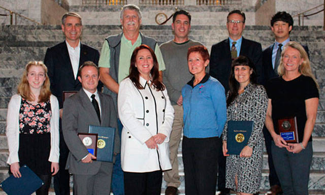 Secretary of State Kim Wyman, third from left, front row, and past winners of the business award. COURTESY PHOTO