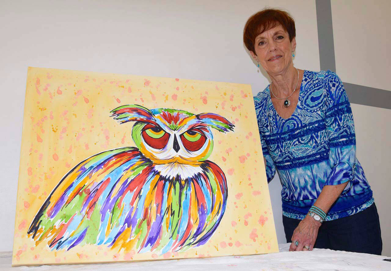 Ronie Schwend shows her painting, ‘Hooo’s Ready For School’ at The Outlet Collection art party. RACHEL CIAMPI, Auburn Reporter