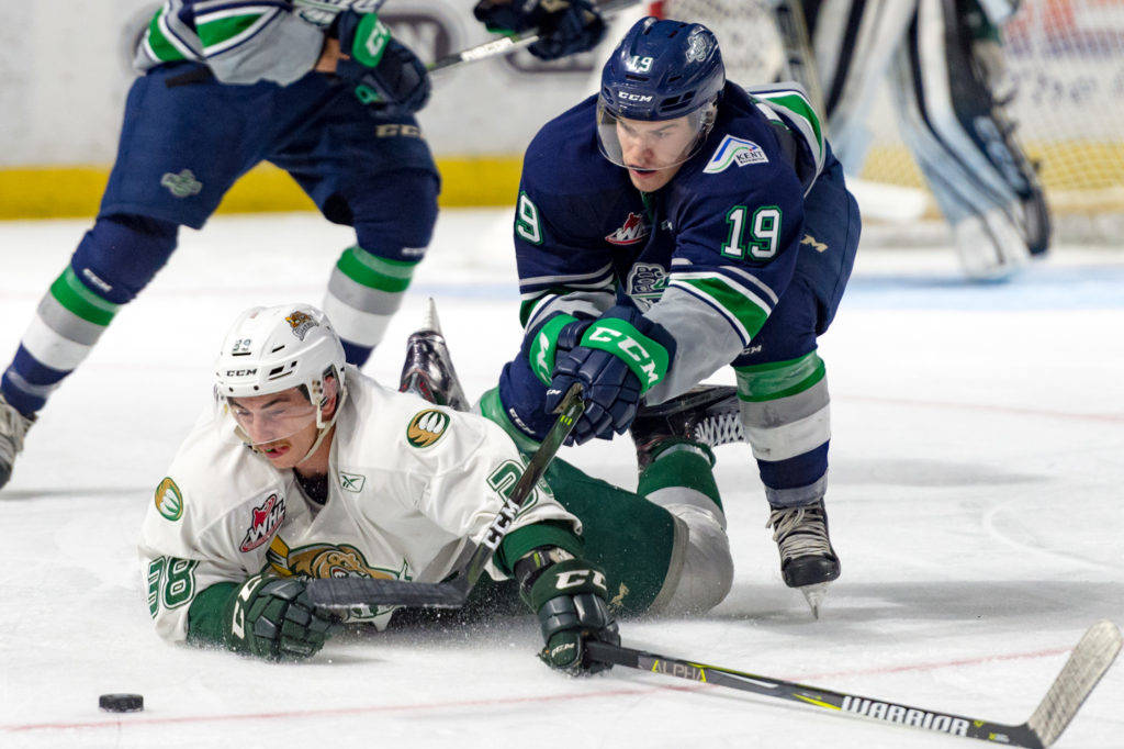 Seattle’s Donovan Neuls and Everett’s Kevin Davis battle for the loose puck during WHL preseason play Saturday night at the ShoWare Center. COURTESY PHOTO, Brian Liesse, T-Birds