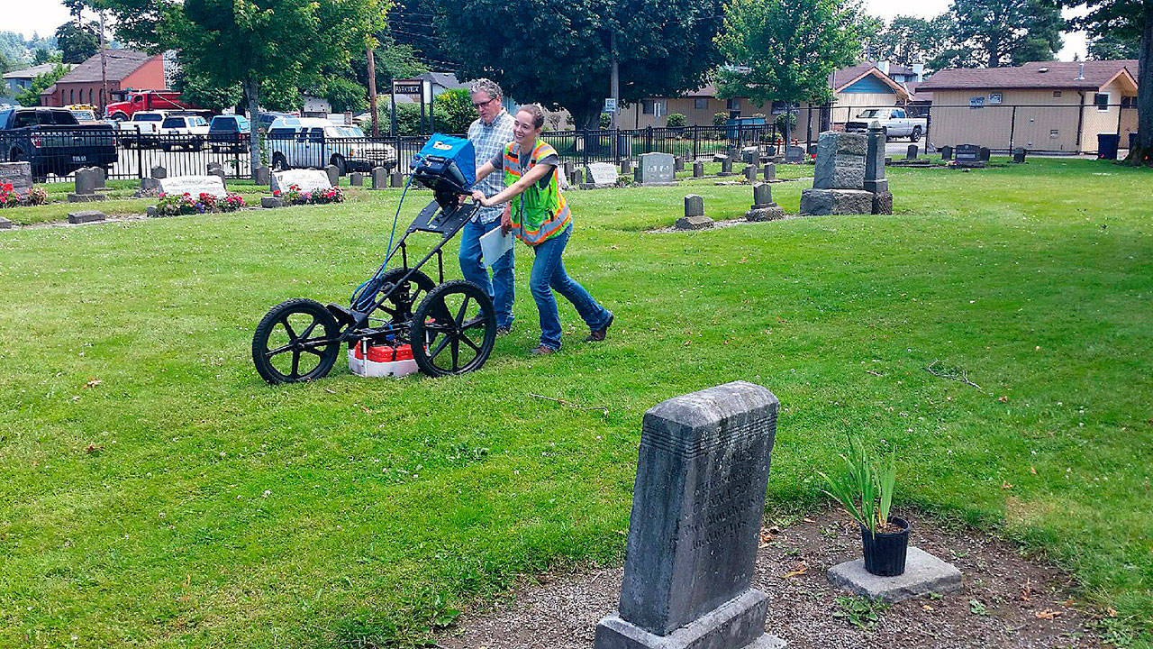 Penhall Company employees wheel a ground-penetrating radar over the turf of Auburn’s Pioneer Cemetery in late June 2016 to determine what if any space remains free below for additional inurnments. ROBERT WHALE, Auburn Reporter