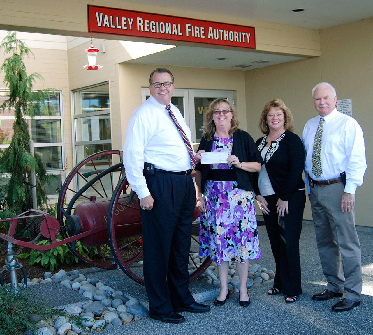 At the check presentation were, from left, Eric Robertson, Valley Regional Fire Authority administrator; Carol Greiling, general manager, Auburn Reporter; Nancy Backus, Auburn mayor and chairman of VRFA Board of Governance; and Police Chief Bob Lee. COURTESY PHOTO