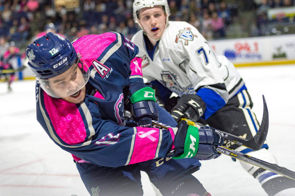 The Thunderbirds’ Blake Bargar advances the puck as the Royals’ Scott Walford defends during WHL play Saturday night at the accesso ShoWare Center. COURTESY PHOTO, Brian Liesse, T-Birds