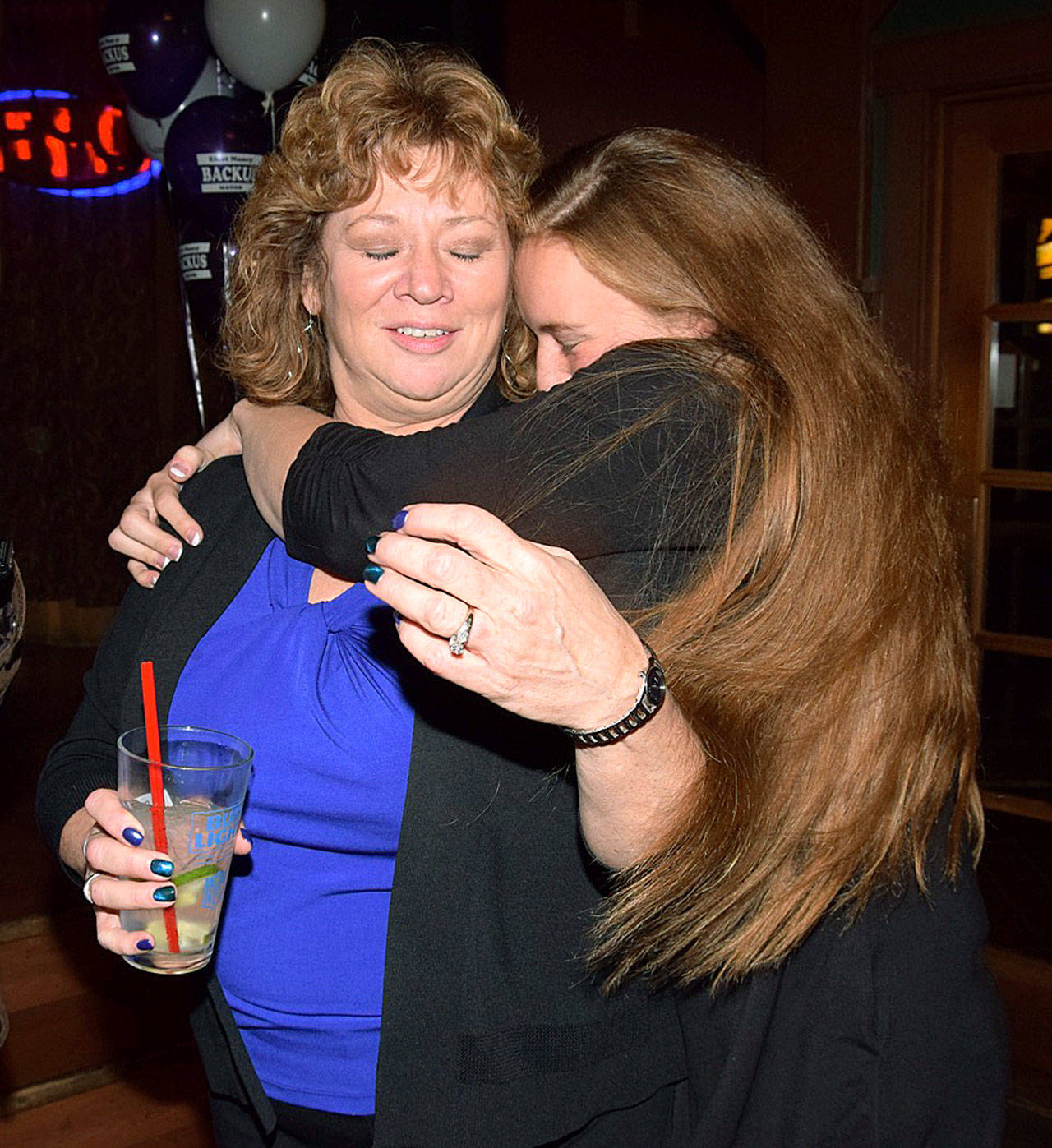 Auburn Mayor Nancy Backus receives a congratulatory hug from her daughter, Lucky, at an election-night campaign gathering at The Longhorn Barbecue on Tuesday. Backus jumped out to a big lead over challenger Largo Wales from early returns. RACHEL CIAMPI, Auburn Reporter