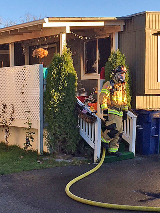 VRFA firefighters quickly put out a fire at an Auburn mobile home park Wednesday. Two boys escaped the fire, but one dog died. COURTESY PHOTO, VRFA