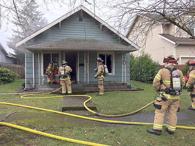A Valley Regional Fire Authority crew mops up a house fire in the 300 block of G Street Southeast on Tuesday morning. COURTESY PHOTO, VRFA