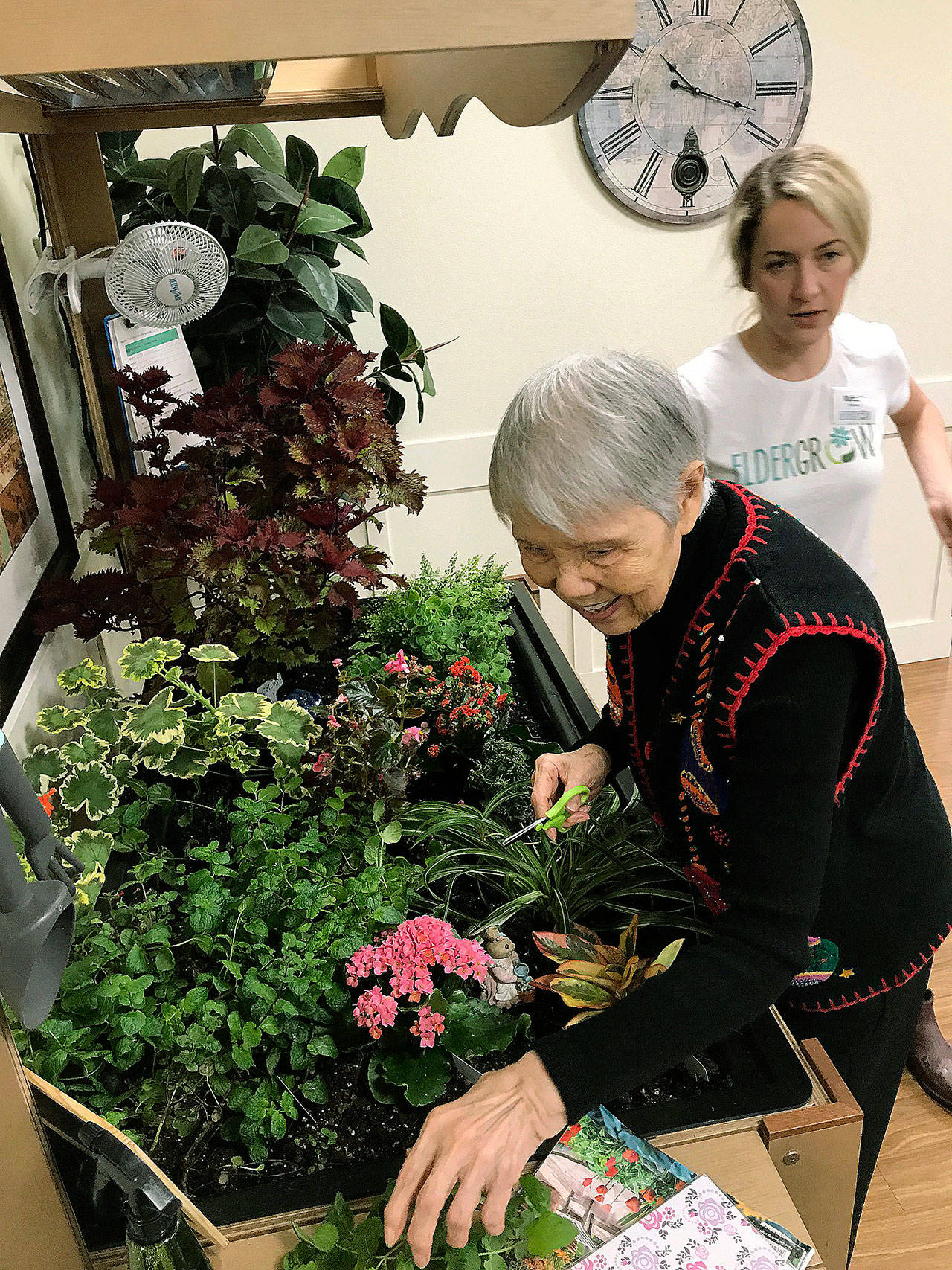 Tamae Delaney, a Brannan Park Retirement community resident, tends the Eldergrow garden with the help of instructor Kristin Herrington-Albrecht. MARK KLAAS, Auburn Reporter