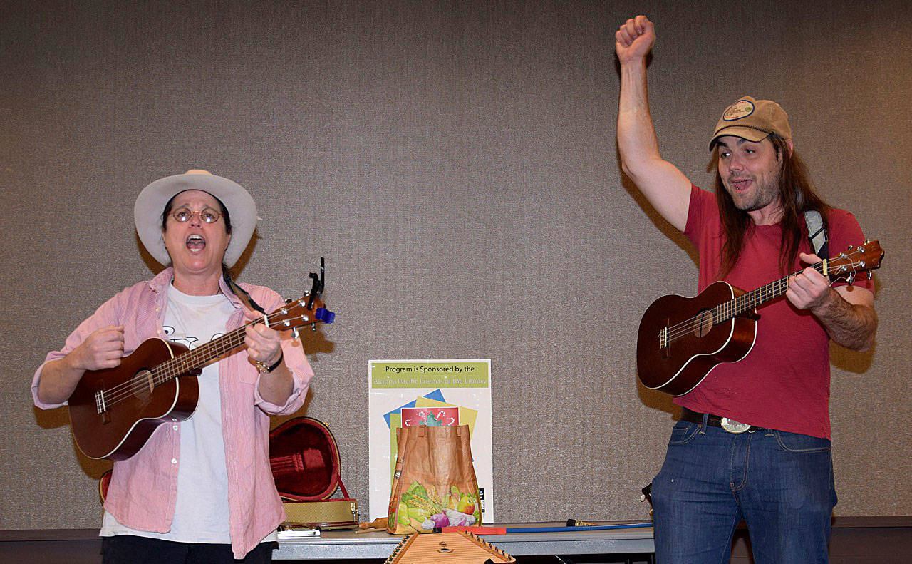 Lisa Taylor, left, and Mike Gervais of the Elephant Umbrella band perform on stage at the Algona Library, part of a recent Fun by the Fireside Sing-Along Show. The family program invited families and children of all ages to enjoy a little song and dance to memorable tunes about fall and winter. For more program information at your nearby public library, visit the King County Library System’s website, kcls.org. RACHEL CIAMPI, Auburn Reporter
