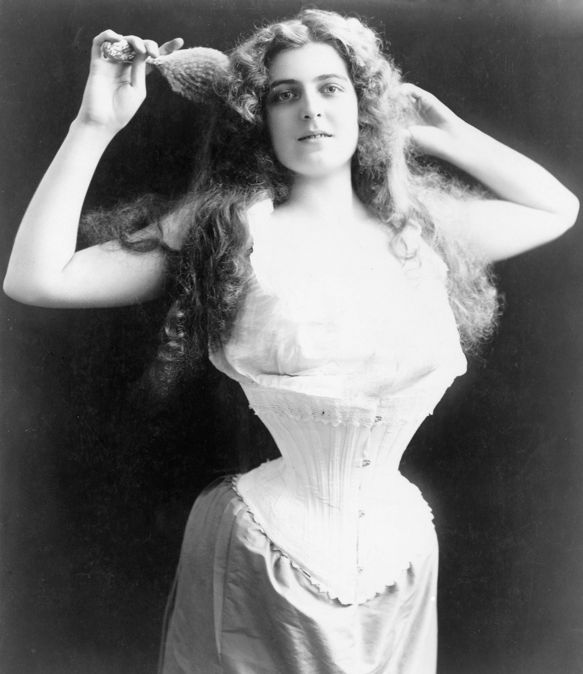 A late 1800s beauty models a corset of the time, designed to push up her breasts, cinch in the waist, and accentuate the backwards flare of her derriere. COURTESY PHOTO, WRVM