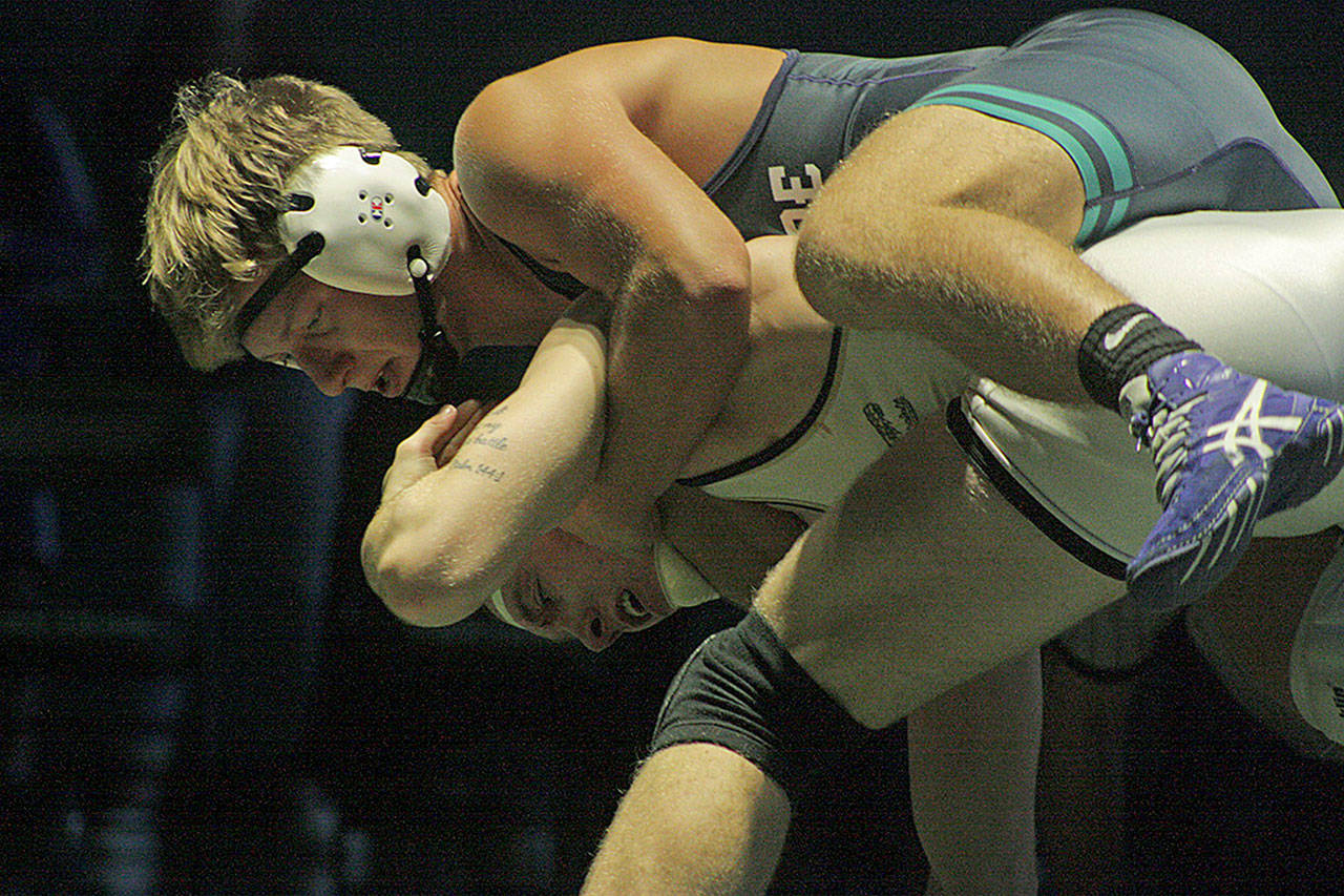 Auburn Riverside’s Sam Onishchenko, top, tangles with Decatur’s Jacob Cassady in the 182-pound final at the Doc Herren Invitational last Saturday. Cassady won 10-3, but the Ravens found strength in numbers to take the team title. MARK KLAAS, Auburn Reporter