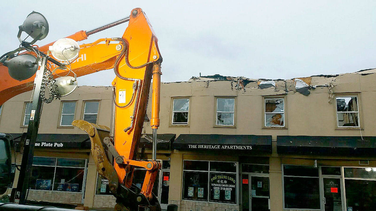 Demolition equipment operated by Servpro Restoration Services takes a respite from demolishing the second floor façade of the burned-out Heritage Building on East Main Street last week. ROBERT WHALE, Auburn Reporter