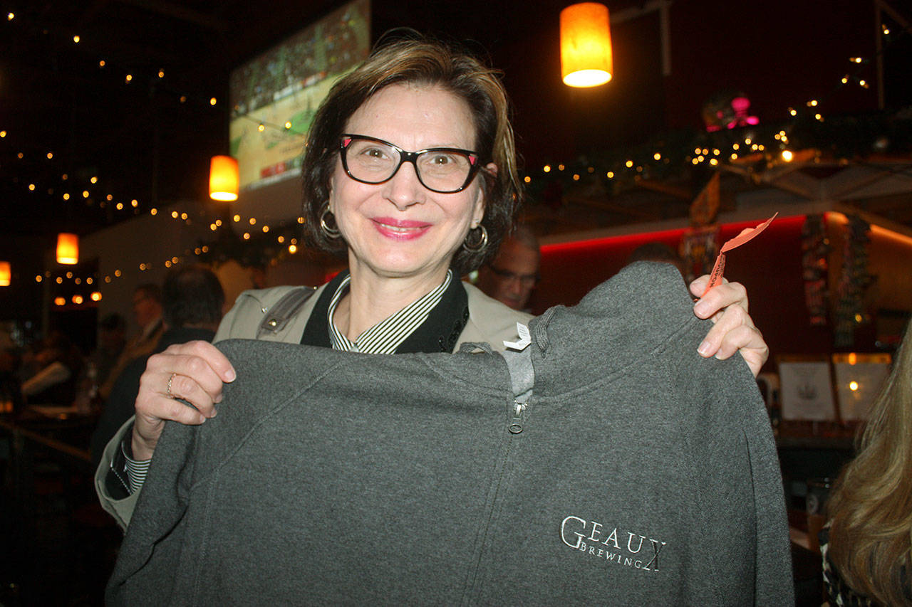 Taryn Hornby shows the Geaux Brewery Hoody she won at a raffle during a benefit program last week to support the Heritage Building fire victims. ROBERT WHALE, Auburn Reporter