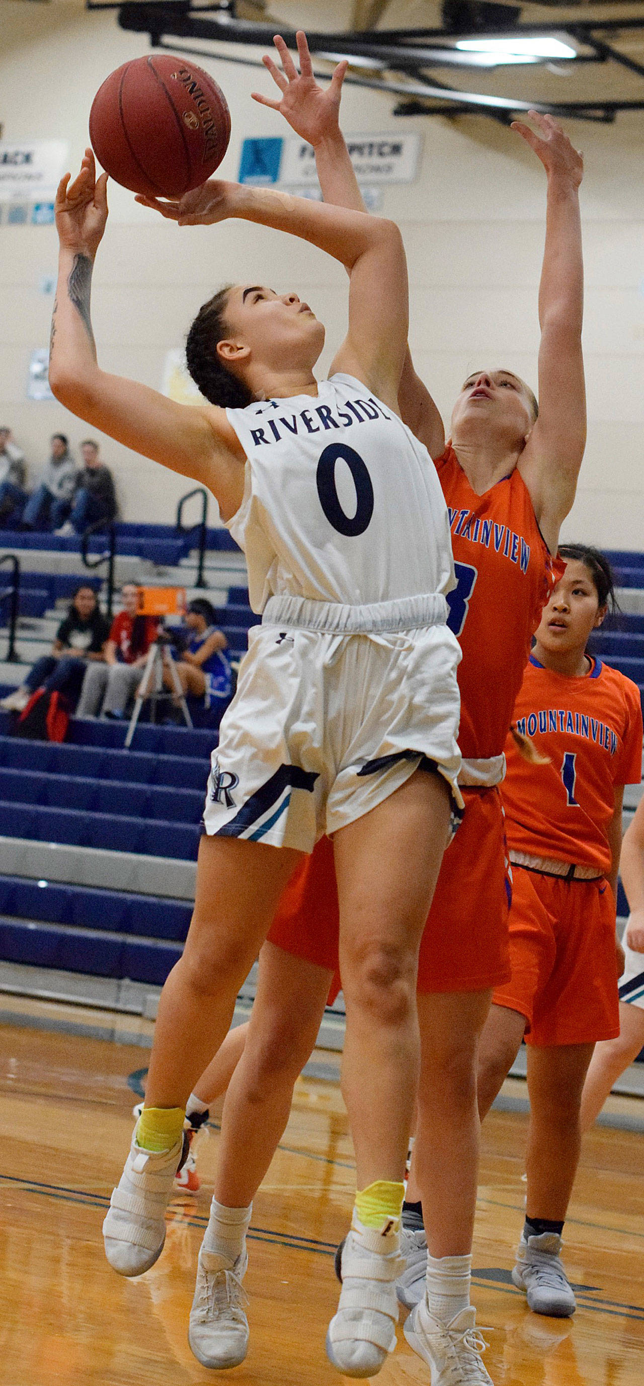 Auburn Riversides Kashe Stansberry goes for the shot but gets it blocked by Auburn Mountainviews Michaela Corbett during NPSL Olympic girls basketball play Wednesday nigth. RACHEL CIAMPI, Auburn Reporter