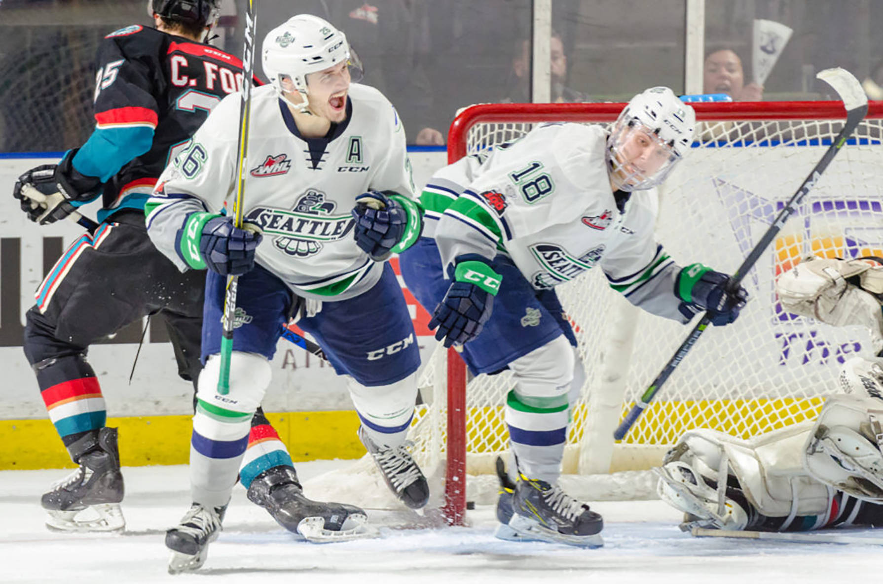 The Thunderbirds’ Nolan Volcan celebrates one of his three goals with teammate Sami Moilanen, right, in front of the Rockets’ net during WHL play Friday night. COURTESY PHOTO, Brian Liesse/T-Birds