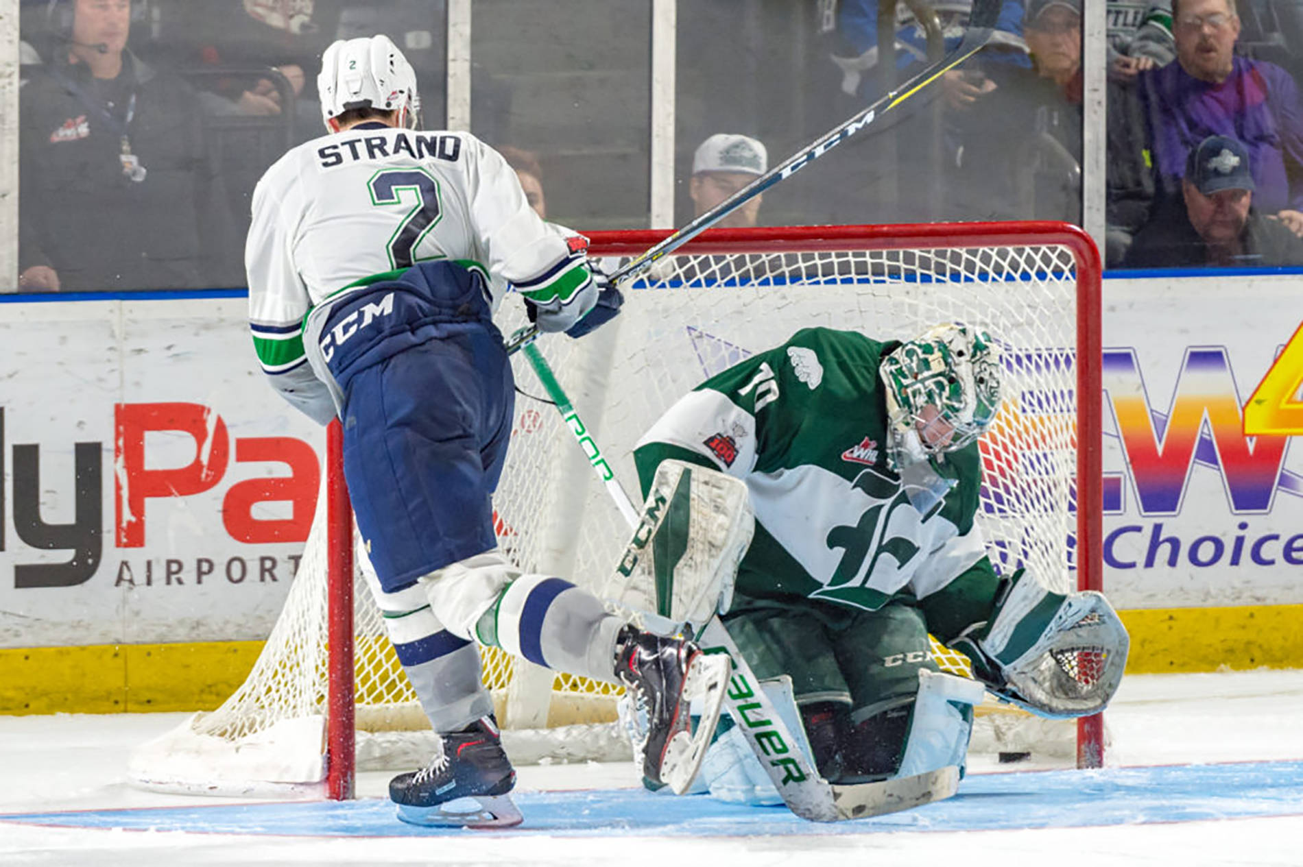 The Thunderbirds’ Austin Strand slides the puck past Silvertips goalie Carter Hart in what turned out to be the game-winning shot in Saturday night’s shootout at the accesso ShoWare Center. COURTESY PHOTO, Brian Liesse, T-Birds