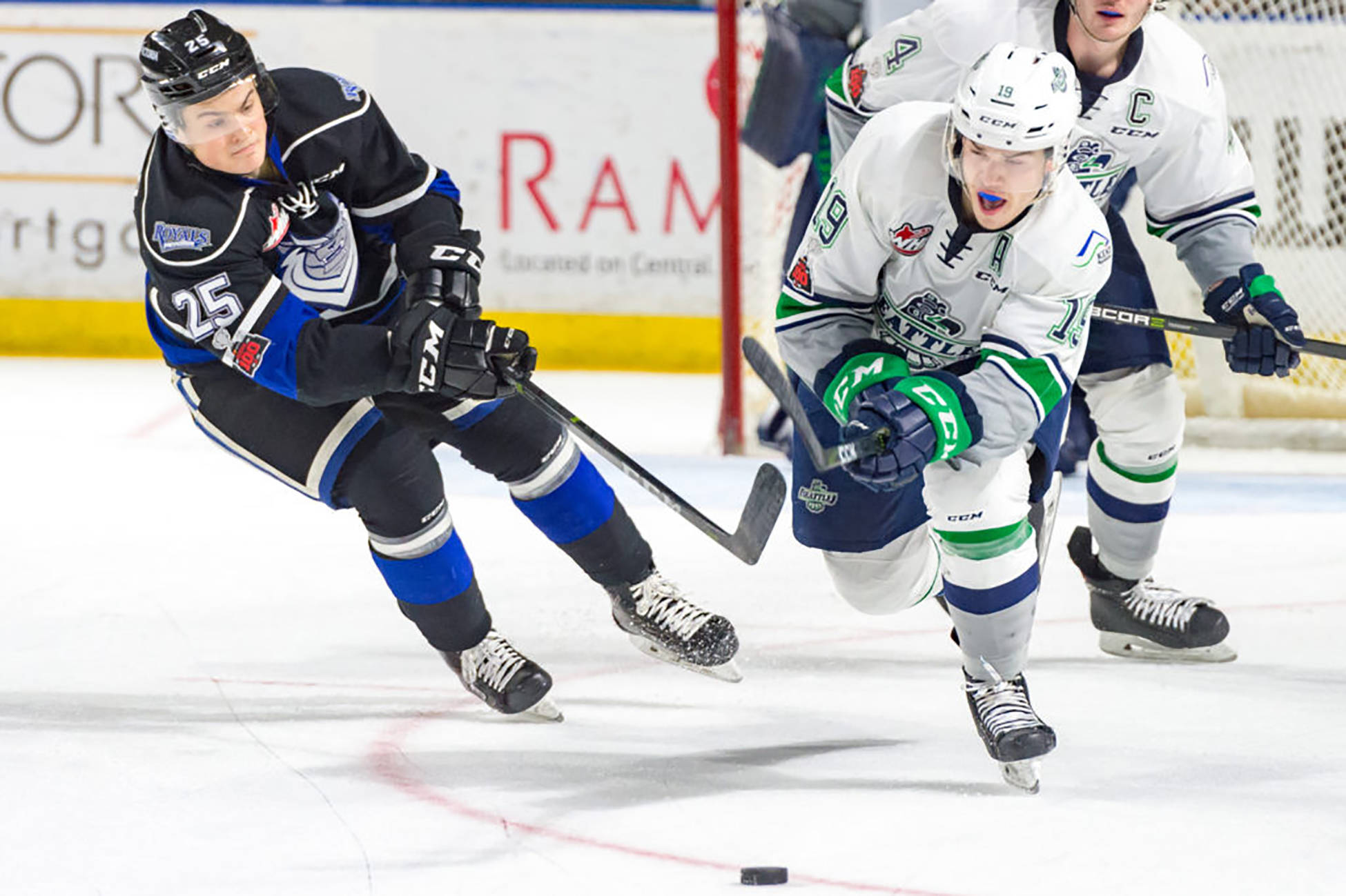 The Thunderbirds’ Donovan Neuls pushes the puck up the ice with the Royals’ Dino Kambeitz in pursuit during WHL play Saturday night. COURTESY PHOTO, Brian Liesse, T-Birds