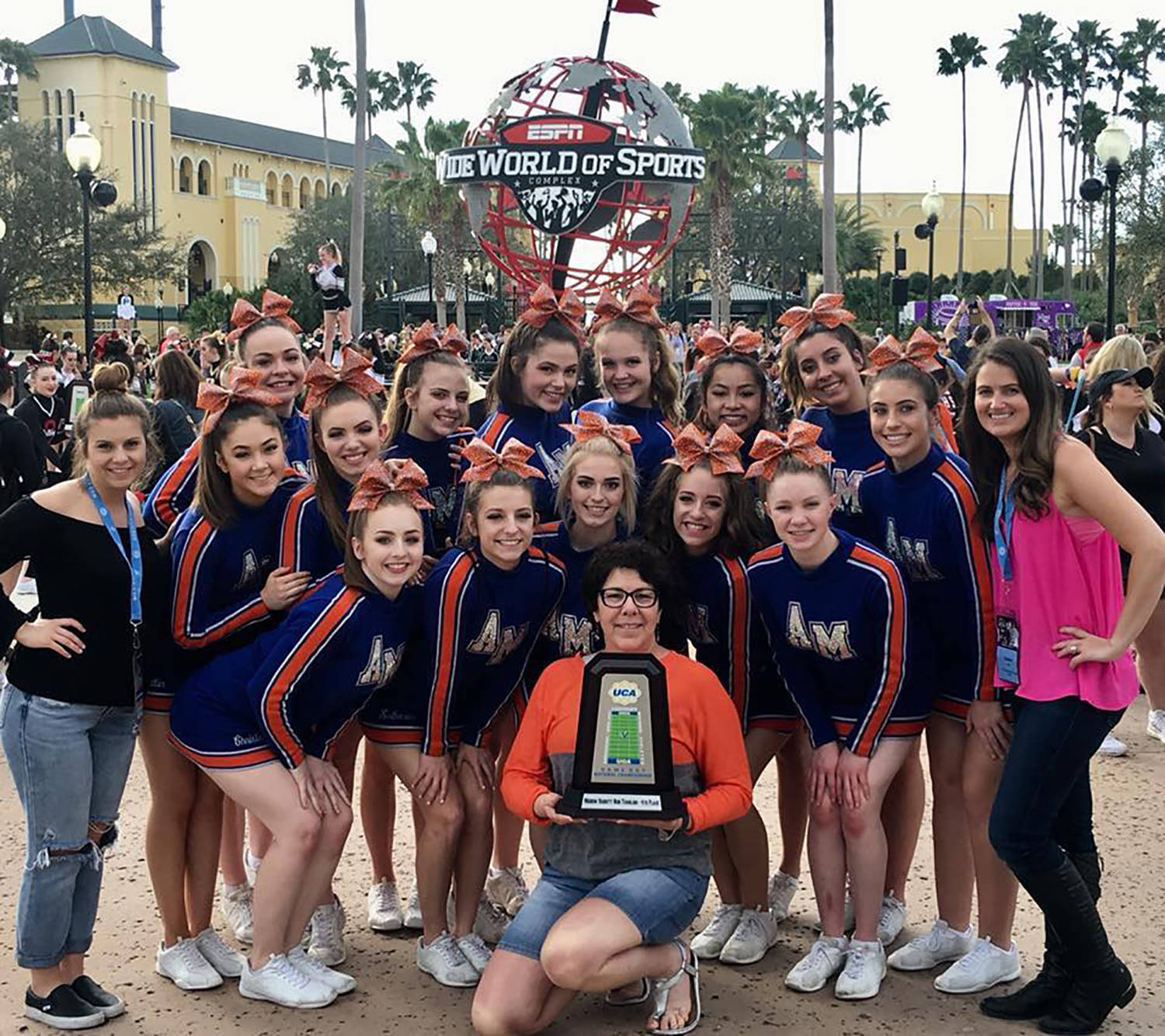 Principal Terri Herren, with the trophy, joins the Auburn Mountainview Cheer Team after its strong performance at the UCA National High School Cheerleading Championships at the Walt Disney World Resort in Orlando, Fla., Feb. 10-11. COURTESY PHOTO