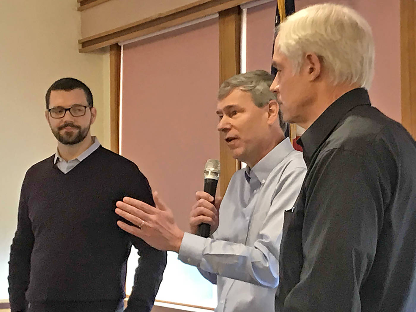 Rep. Pat Sullivan, D-Covington, fields a question from the audience as Sen. Joe Fain, R-Auburn, left, and Mark Hargrove, R-Covington, look on during a District 47 town hall meeting at the Golden Steer Steak N’ Rib House in Kent last Saturday. MARK KLAAS, Kent Reporter