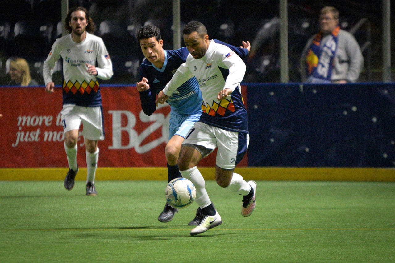 The Stars’ Jamael Cox battles a defender in driving the ball up the field during playoff action Thursday night. COURTESY PHOTO, Stars