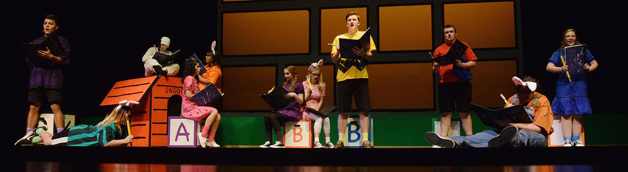 Colton DeCarteret (Charlie Brown), Jeffrey Page (Linus, red shirt), Anna Van Vleet (Lucy, blue dress) and Daniel Silva (Shroeder, purple stripe shirt) perform ‘The Book Report song’ with other cast members. RACHEL CIAMPI, Auburn Reporter
