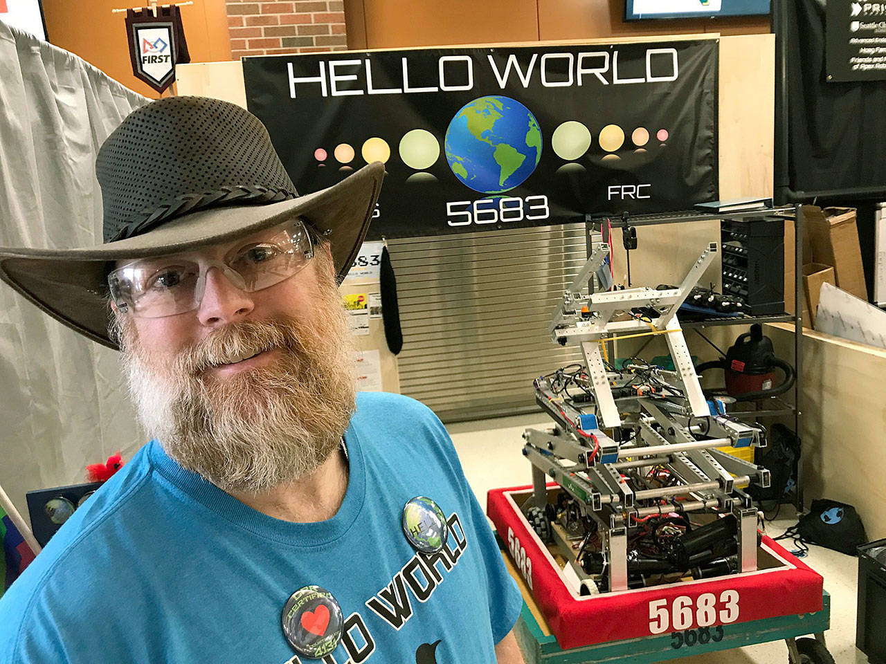 Kim Markham, a robot programmer at The Boeing Co., works part-time as coach and mentor of Auburn Riverside’s robotics team, which designed and engineered Hello World 5683. MARK KLAAS, Auburn Reporter