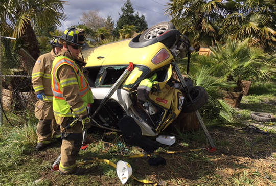 VRFA firefighters examine the scene of a one-car wreck that claimed the life of the driver. COURTESY PHOTO, VRFA