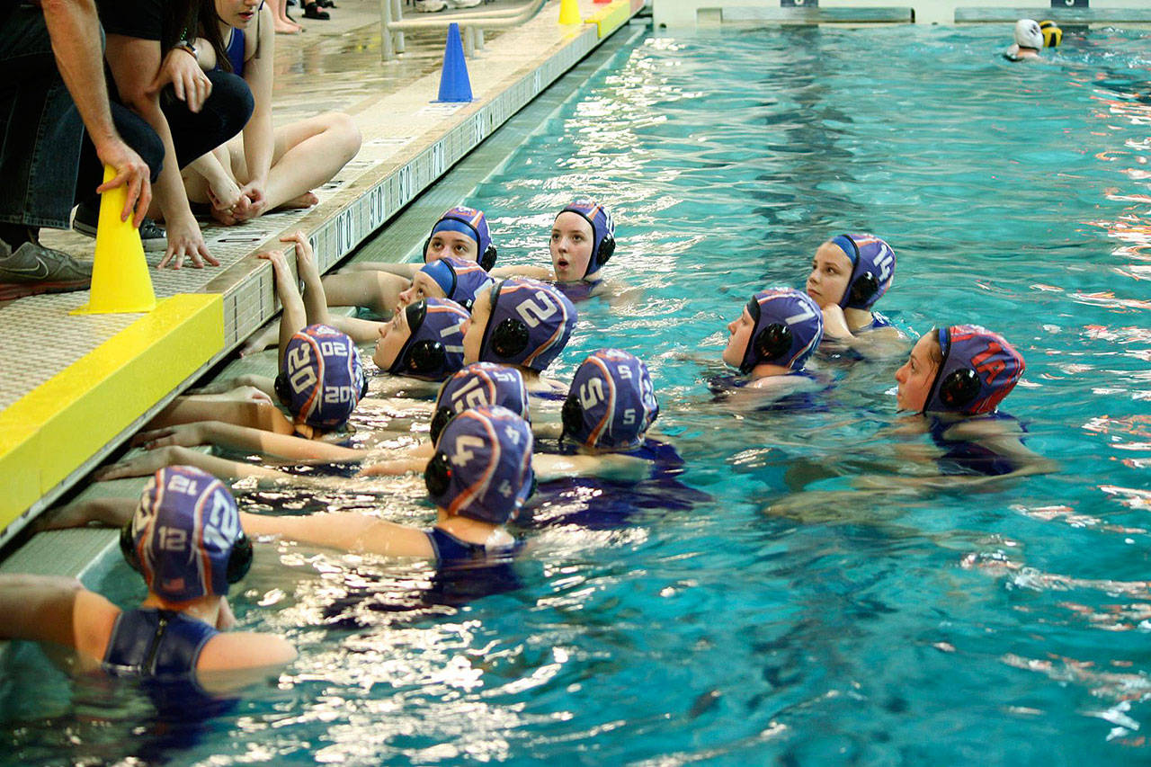 The Auburn Mountainview girls water polo team listens to instruction during a timeout. COURTESY PHOTO