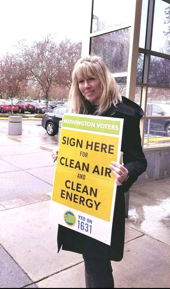 An Alliance for Jobs and Clean Energy representative activist gathers signatures for the Yes on 1631 initiative at the Redmond Library on April 8. Photo courtesy of Alliance for Jobs and Clean Energy Facebook