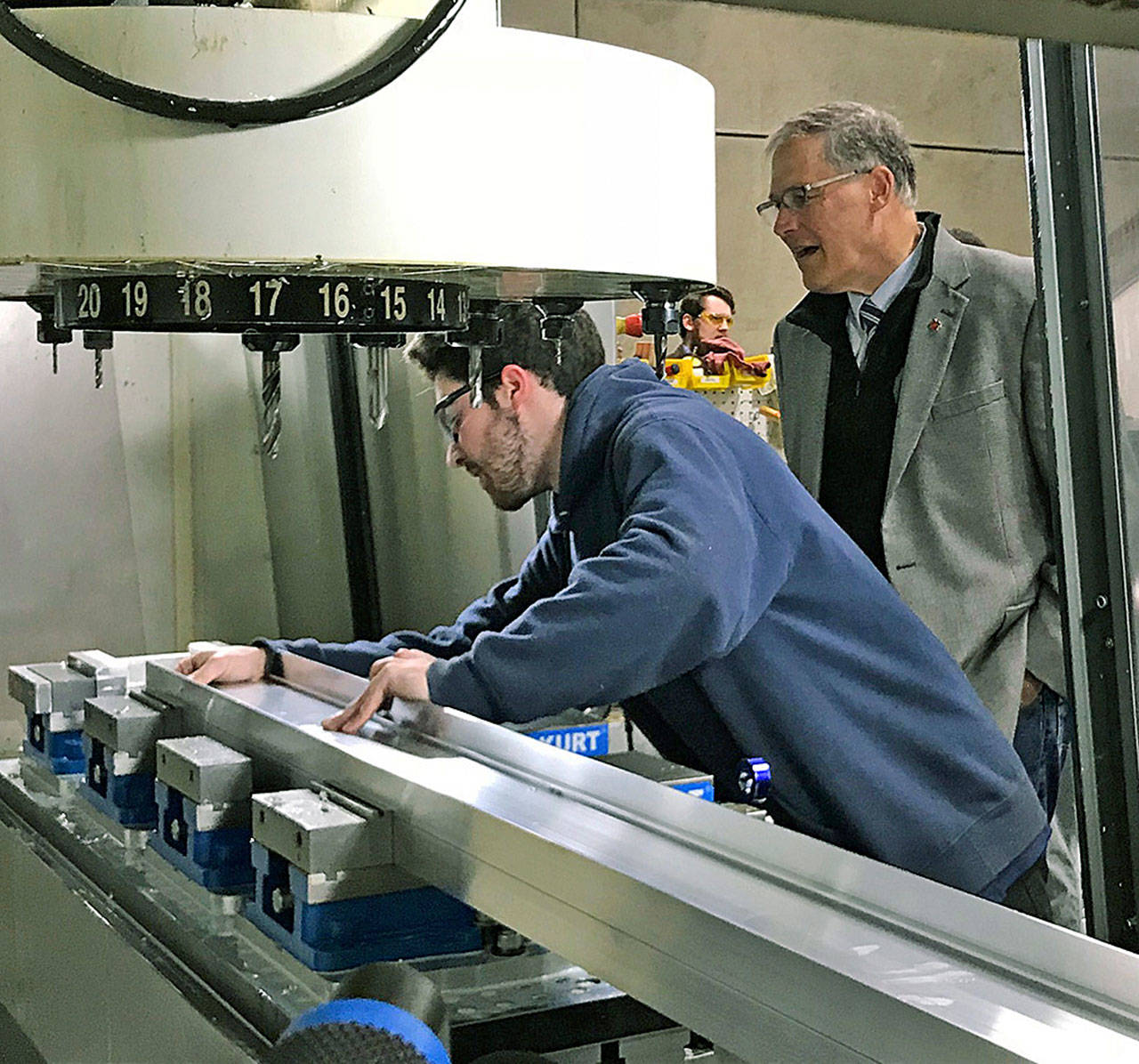 Sean Colyer, a junior apprentice, shows Gov. Jay Inslee how he manufactures aluminum joists for building assembly during the governor’s tour of American Structures Design, Inc., in Pacific last Friday. MARK KLAAS, Auburn Reporter