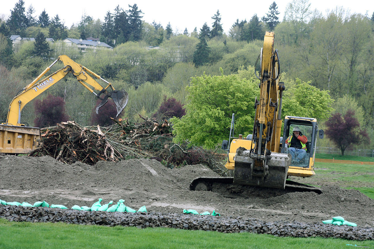 Crews continue to clear the way for development at Riverbend’s former par 3 golf course this week along West Meeker Street. MARK KLAAS, Kent Reporter