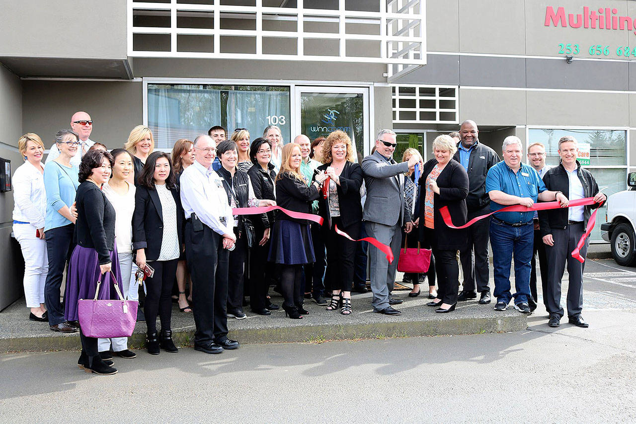 Kent Mayor Dana Ralph and Auburn Mayor Nancy Backus and the Auburn Area and Kent Chambers of Commerce joined company representatives at a ribbon cutting ceremony at the WinnComm facility in Kent on April 19. COURTESY PHOTO