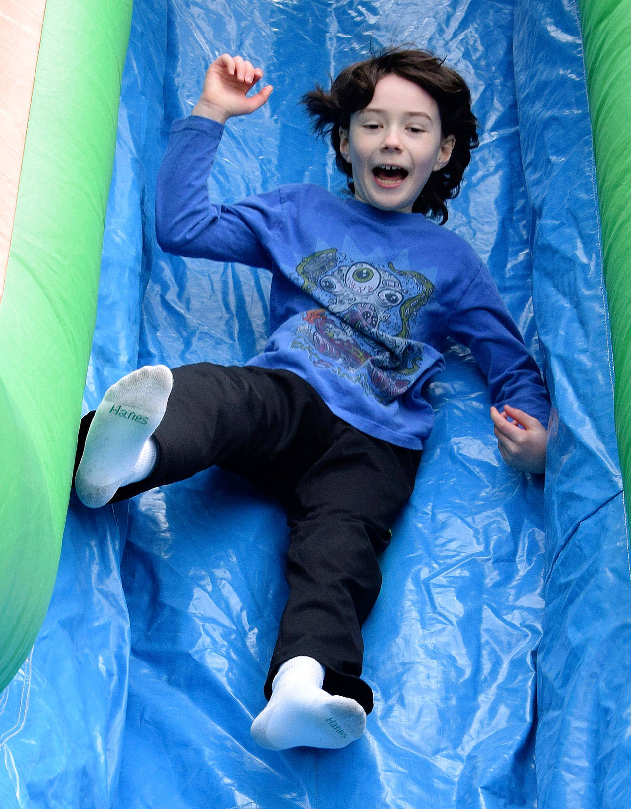 Gabriel Hall, 9, zips down the inflatable slide. RACHEL CIAMPI, Auburn Reporter