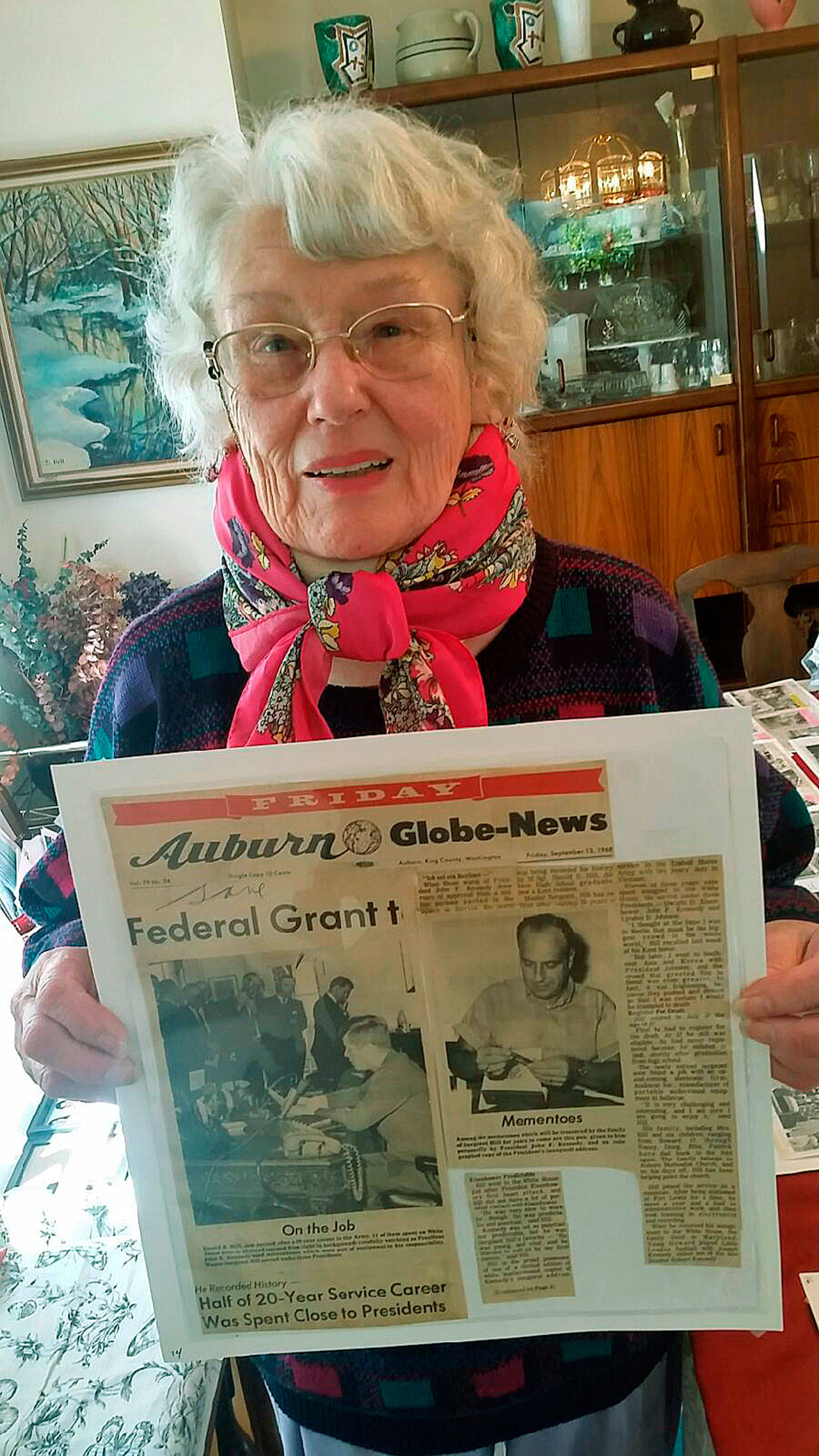 Sylvia Hill displays a newspaper article about her late husband, Harold Hill, and the three Presidents he served during his 11 years as a communications specialist in the White House. Hill died April 6 at 87. A memorial service for the 1948 Auburn High School graduate is at 1 p.m. May 19 at First United Methodist Church in Auburn. ROBERT WHALE, Auburn Reporter