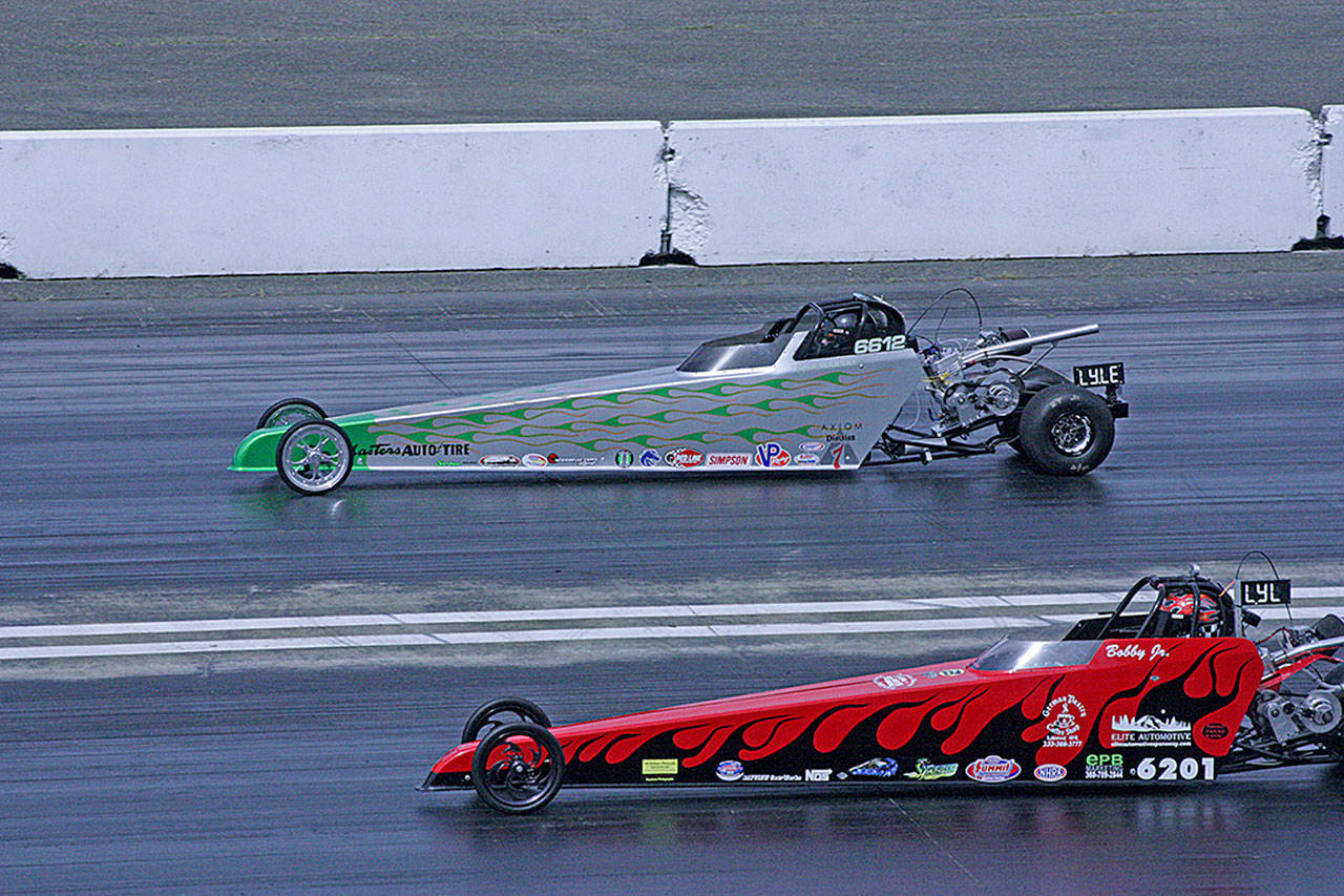 Renton’s Ryan Warnke, above, duels Bobby Burkevies Jr., during a qualifying run in the Junior Dragster Lightning category at Pacific Raceways last Saturday. Area teams converged at the drag strip for the inaugural Mark Lyle Junior Invitational, a tribute race for the late NHRA chief official starter who began his career at the Kent track. MARK KLAAS, Kent Reporter