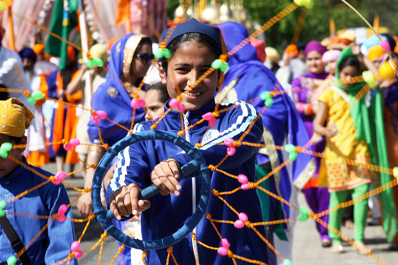 Eaknoorjit Kaur Dhaliwal, of Surrey, British Columbia, twirls a ring during the Khalsa Day Celebration and Parade through the streets of Kent last year. MARK KLAAS, Kent Reporter