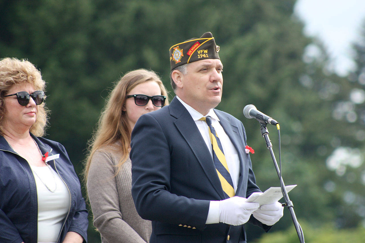 Tony Whetstine, post commander of VFW Post 1741, addresses the crowd, with Mayor Nancy Backus and her daughter, Lucky, at the Memorial Day ceremony. MARK KLAAS, Auburn Reporter