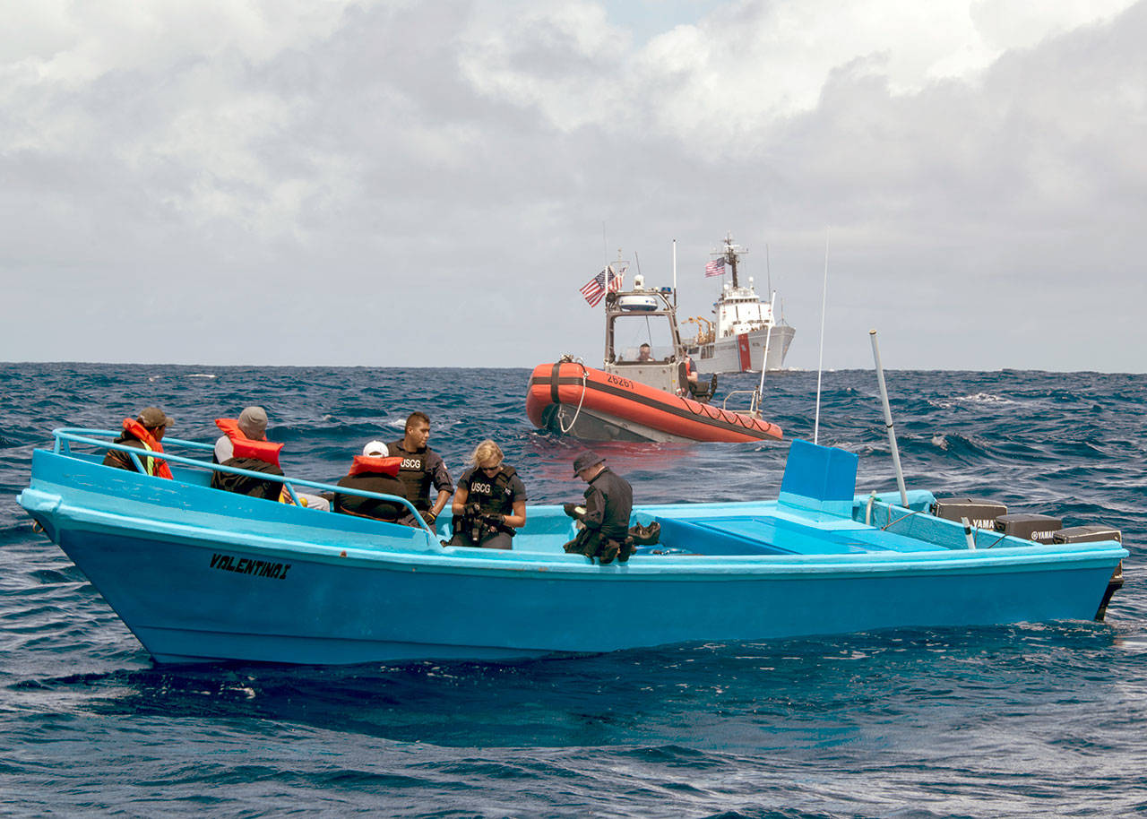 The crew of the Coast Guard cutter Active, a 210-foot medium endurance Reliance-class cutter homeported in Port Angeles, interdicts more than 1 ton of cocaine from four suspected drug smugglers during a counter-narcotics patrol in the eastern Pacific Ocean on May 18. (U.S. Coast Guard)